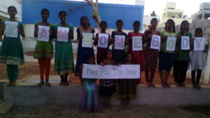 Photo of the girls of the Barbara Kelly Home in Chennai, India holding their fingerprint artwork for the I Am Somebody campaign.