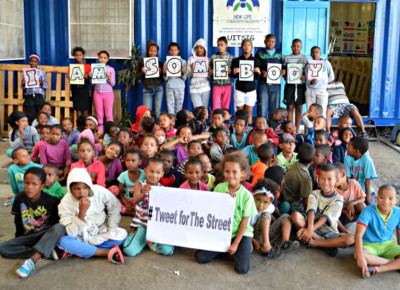 Photo of children at New Life, South Africa holding their fingerprint artwork for the I Am Somebody campaign.